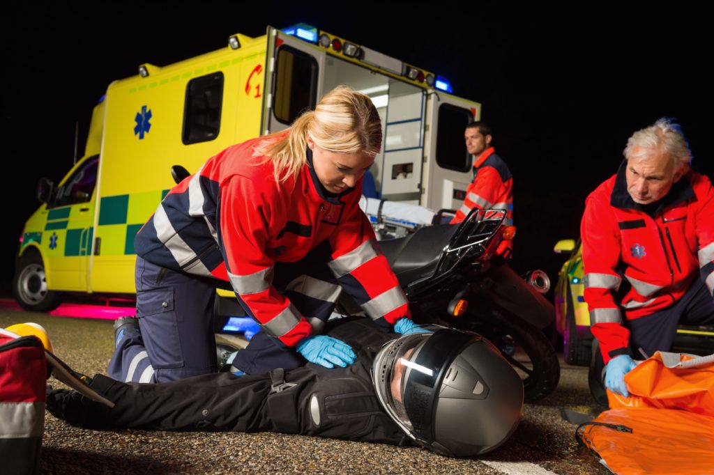 abulance team caring for motorcycle driver